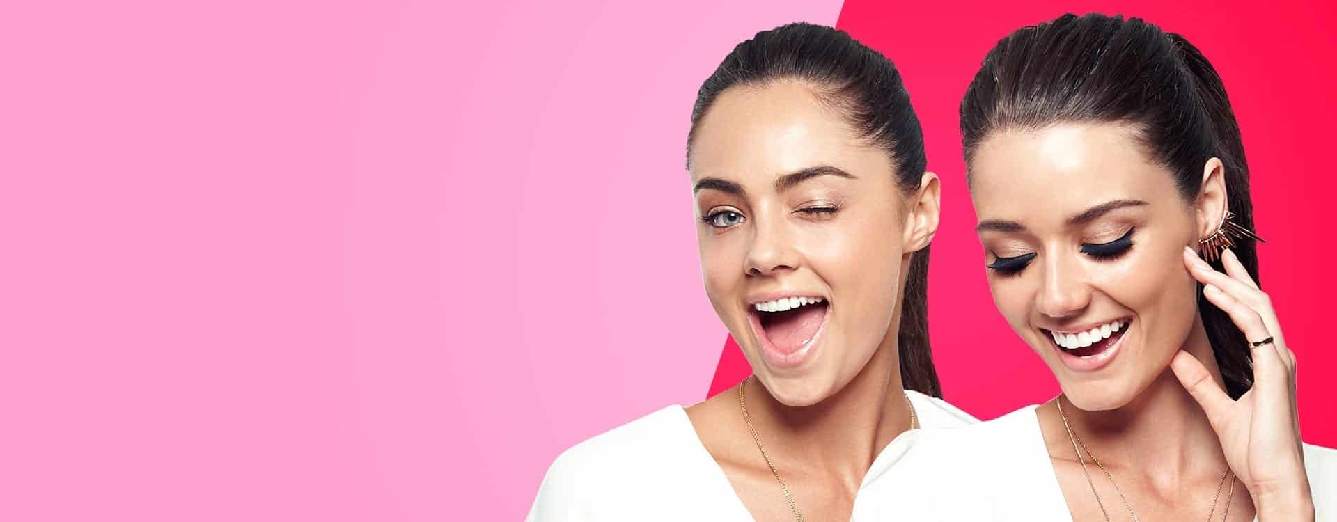 Beauty campaign image of a cheerful woman with bold makeup and glowing skin, developed by Reborn Digital Marketing Agency on a pink gradient background.