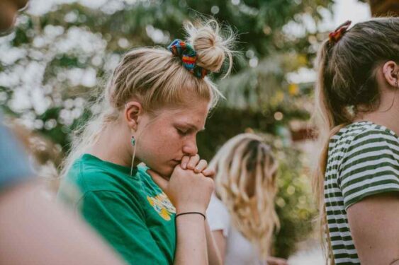 Young blonde woman closing her eyes